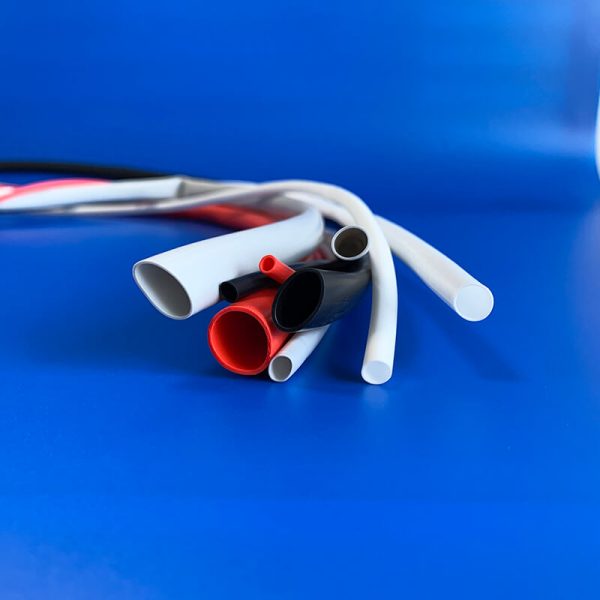 Flexible silicone heat shrink tubing in black, white, and red for wire insulation and protection